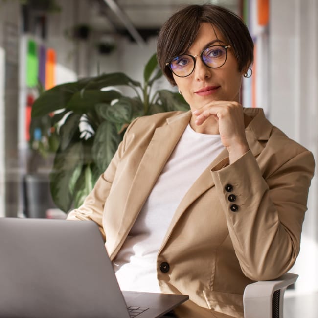 medium shot woman working with laptop 2